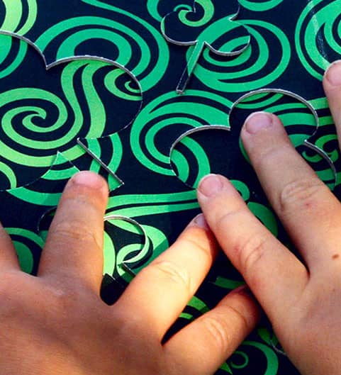 Find me! Fingers of children reading a tactile board during the workshop