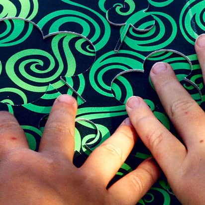 Find me! Fingers of children reading a tactile board during the workshop