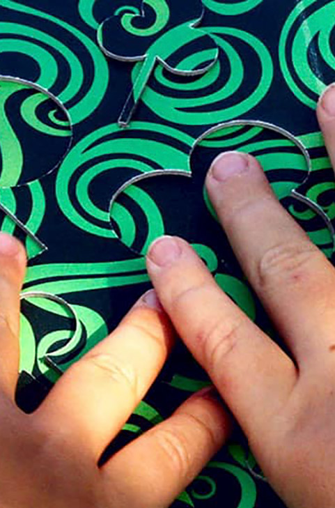 Find me! Fingers of children reading a tactile board during the workshop